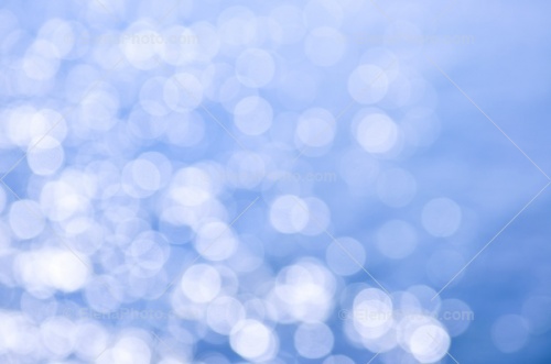 Out Of Focus Bokeh Background Blue Water With Sun Reflections Can