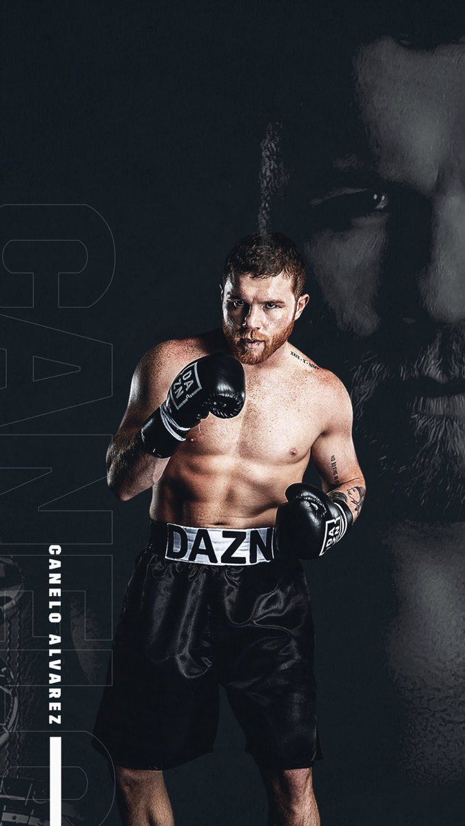 A Man Wearing Boxing Gloves Standing In Front Of Black Background Wallpaper