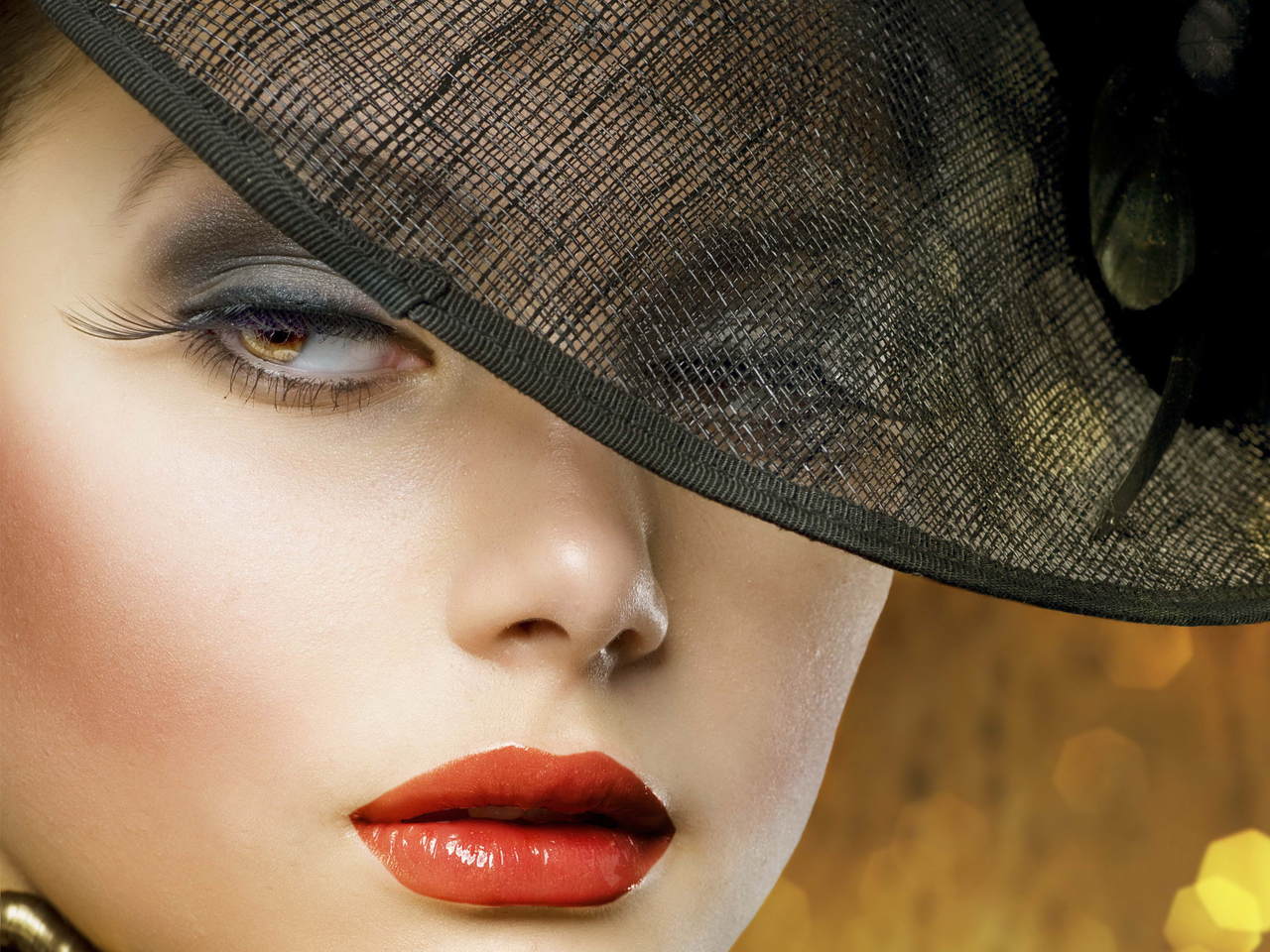 Close-up of a woman's face with dramatic makeup and a stylish hat, evoking classic Hollywood glamour