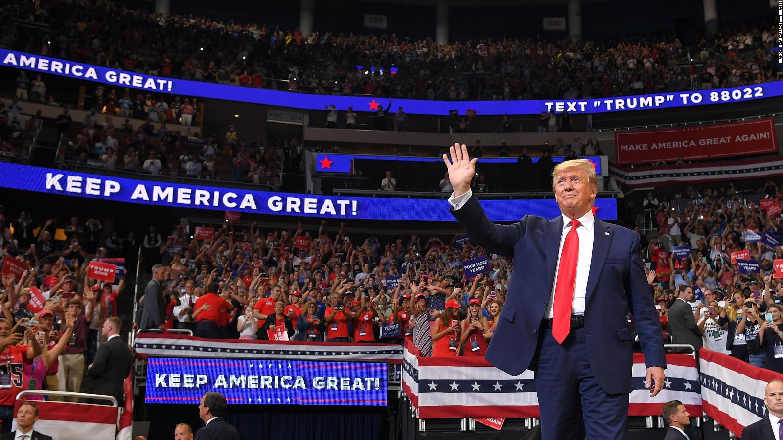 Donald Trump waves to a cheering crowd at a 2024 presidential campaign rally