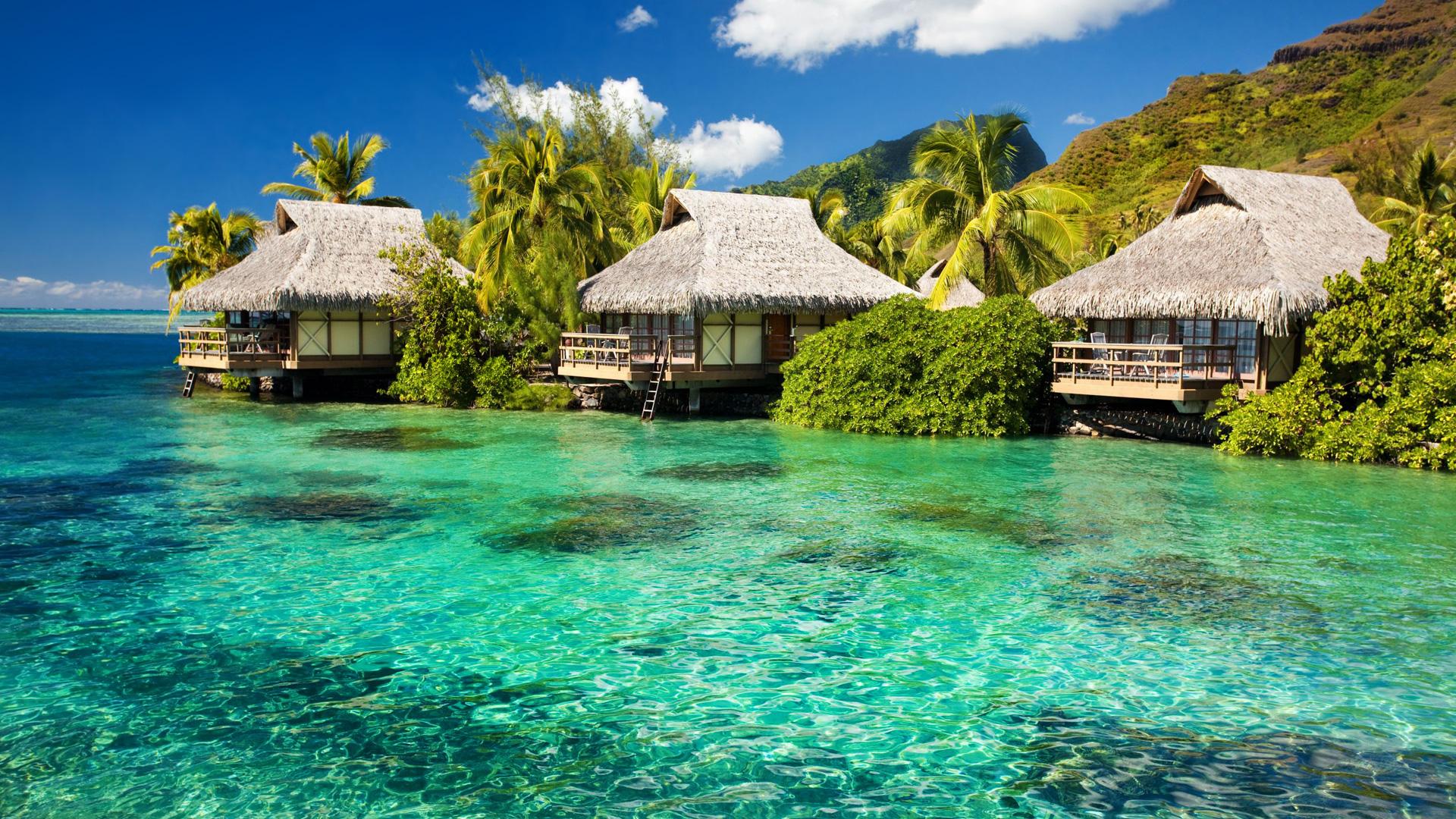 Tropical bungalows over a beautiful turquoise lagoon in Bora Bora, French Polynesia