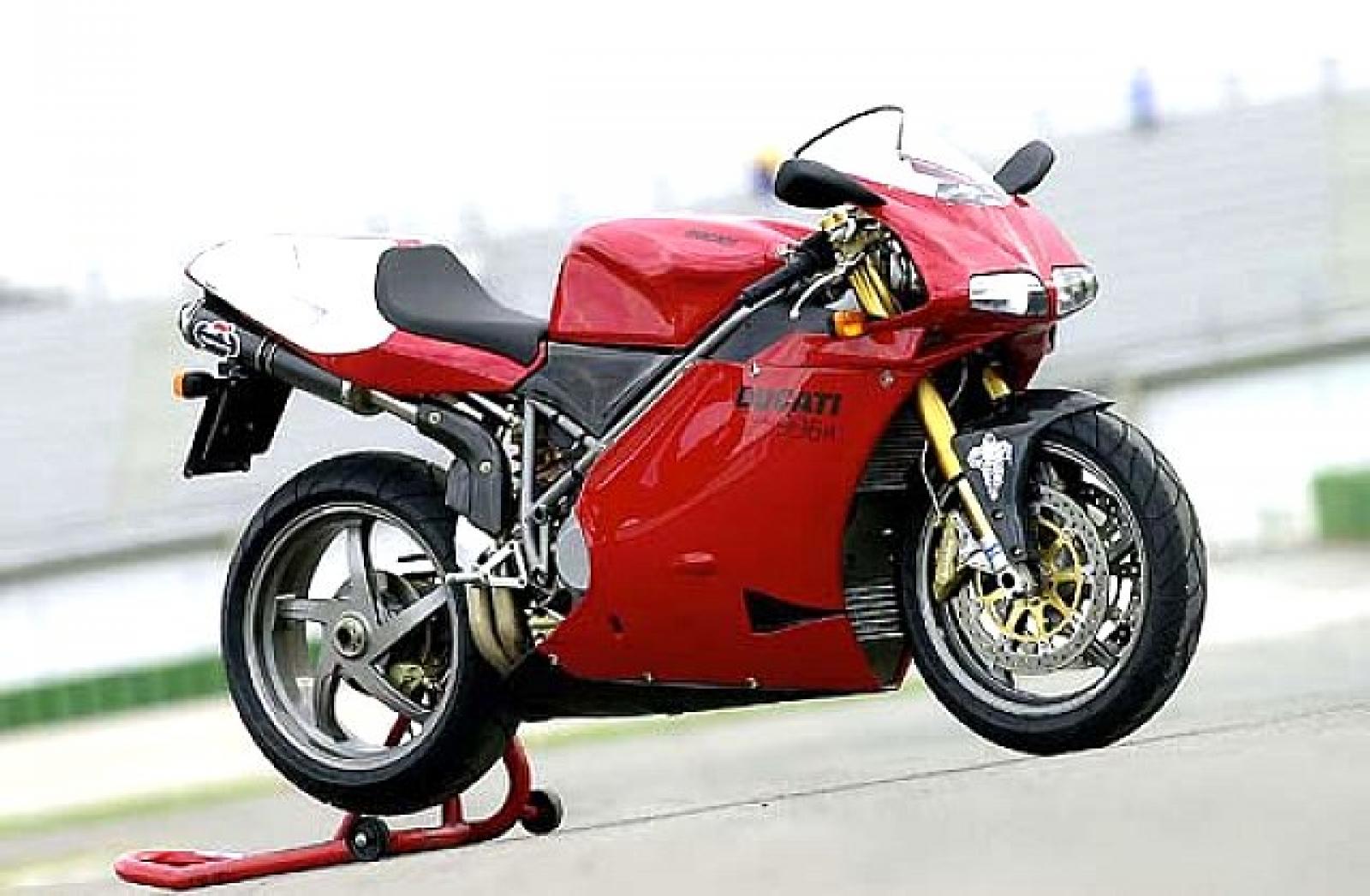 Red and white Ducati 996 motorcycle parked on a race track