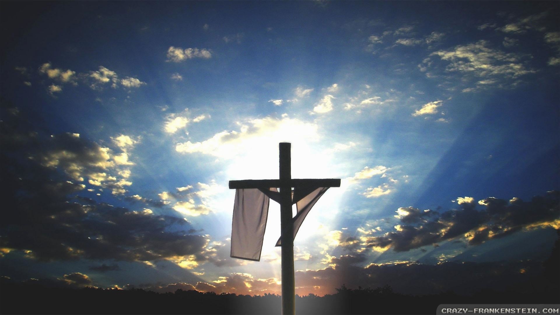 A wooden cross silhouetted against a vibrant sunset sky, symbolizing Jesus's sacrifice and resurrection