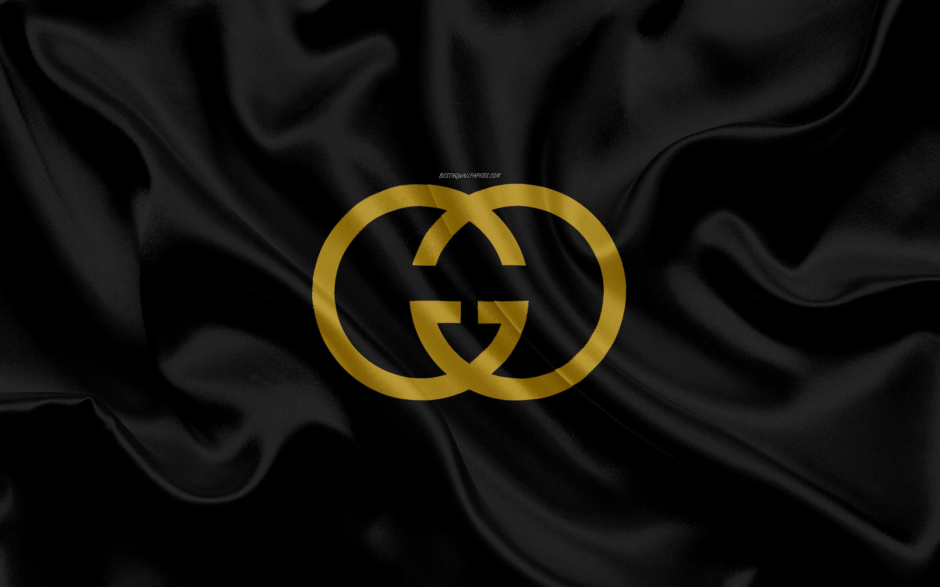 Gucci logo on a black silk background