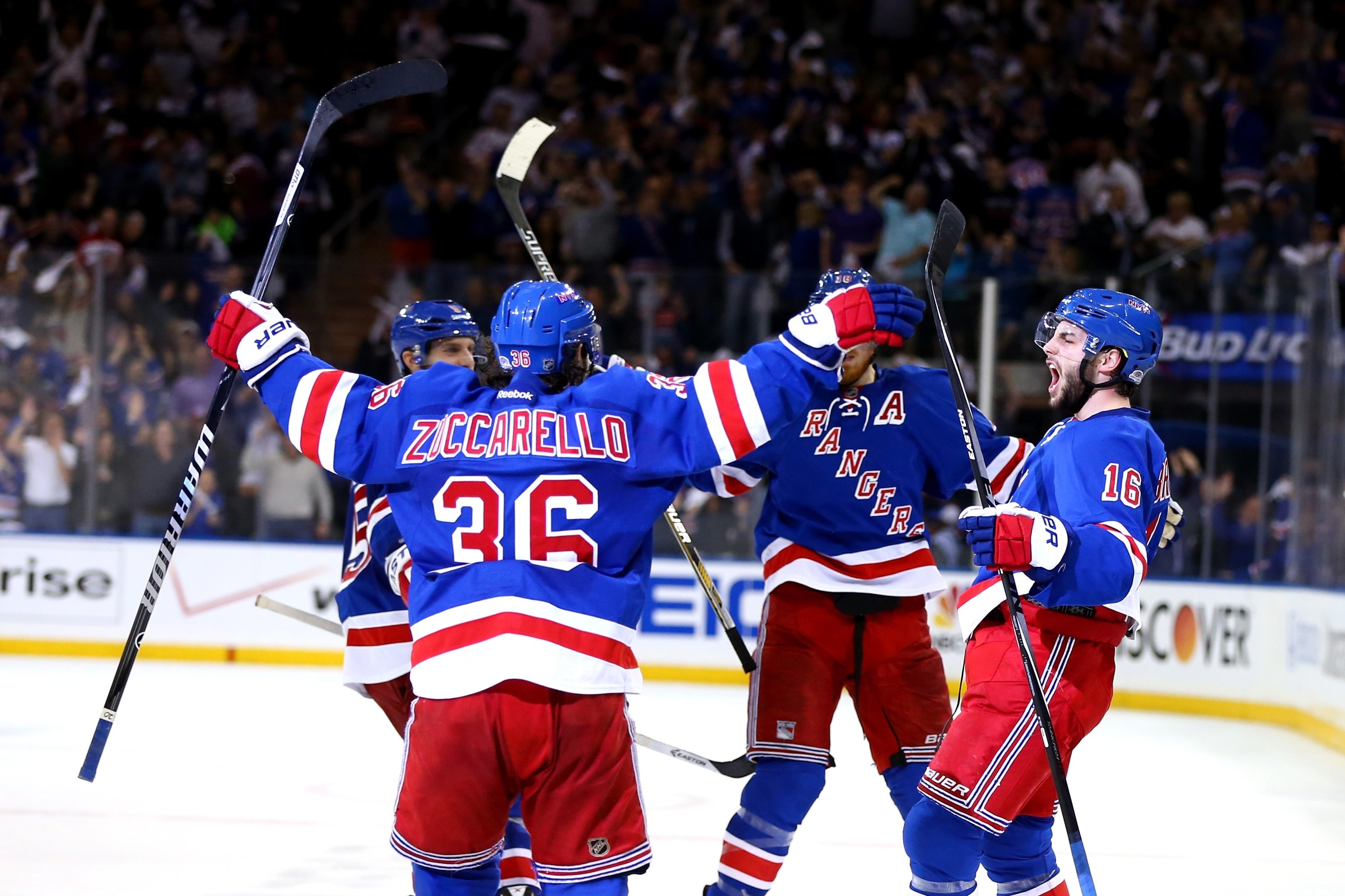 New York Rangers players celebrating a goal on the ice