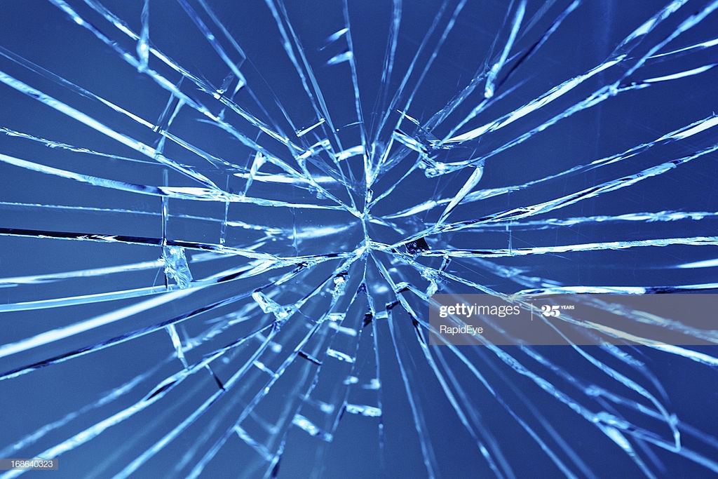 Smashed Window With Multiple Cracks Against Blue Background High