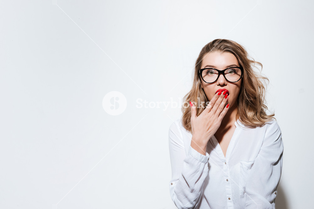 Portrait Of A Young Surprised Woman In Eyeglasses Looking At