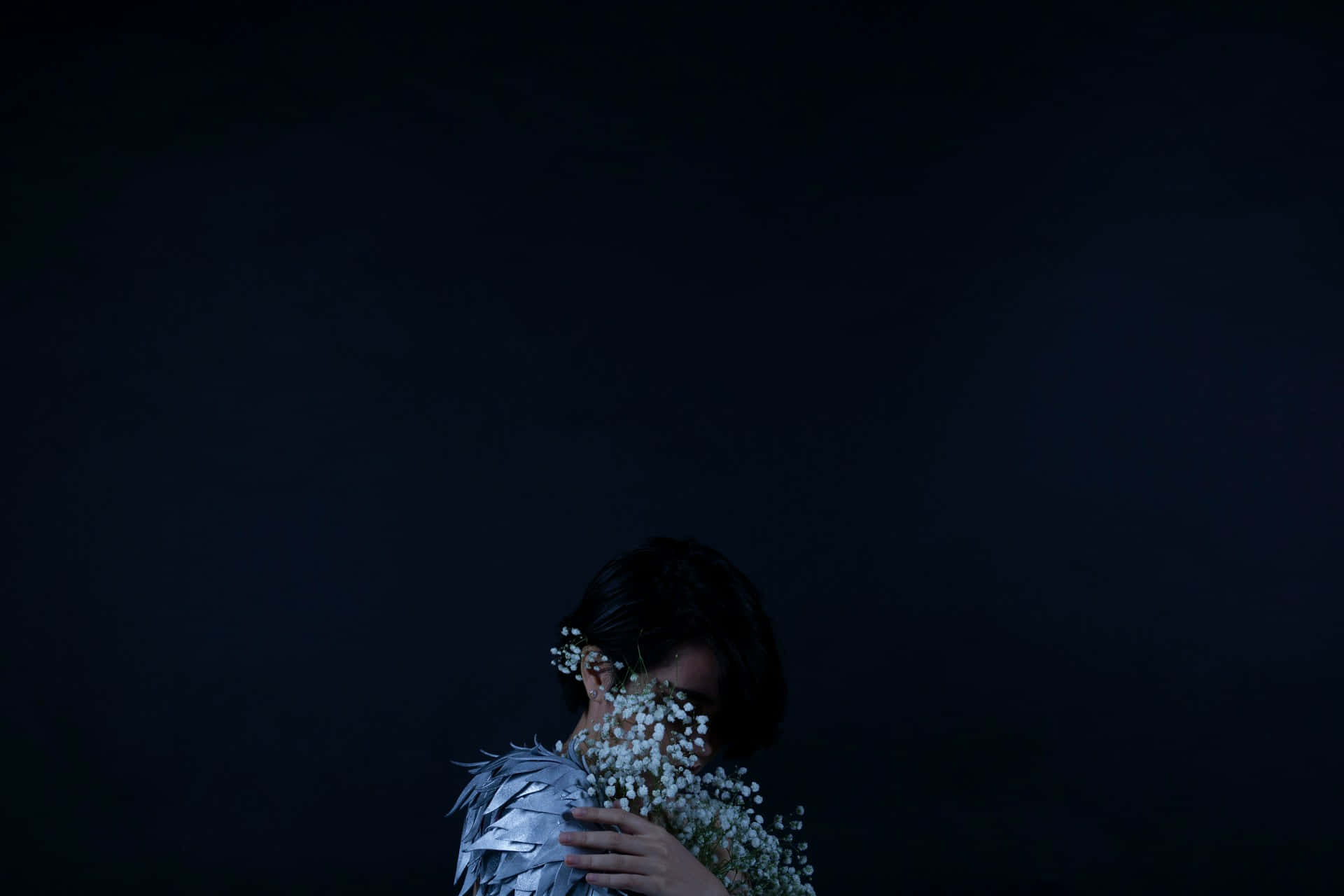 Timid Person Holding Flowers Dark Wallpaper