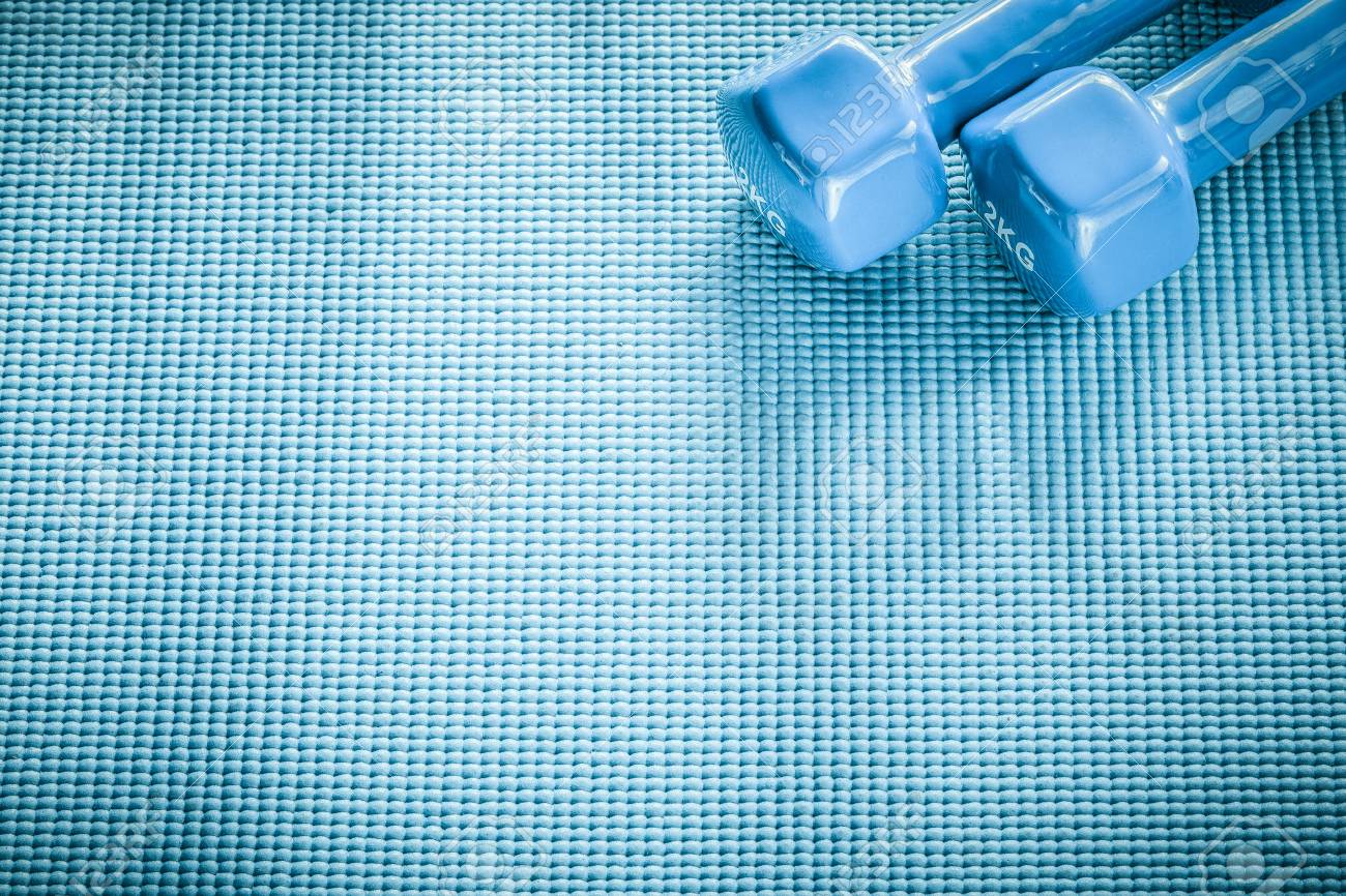 Dumb Bells On Blue Background Fitness Concept Stock Photo