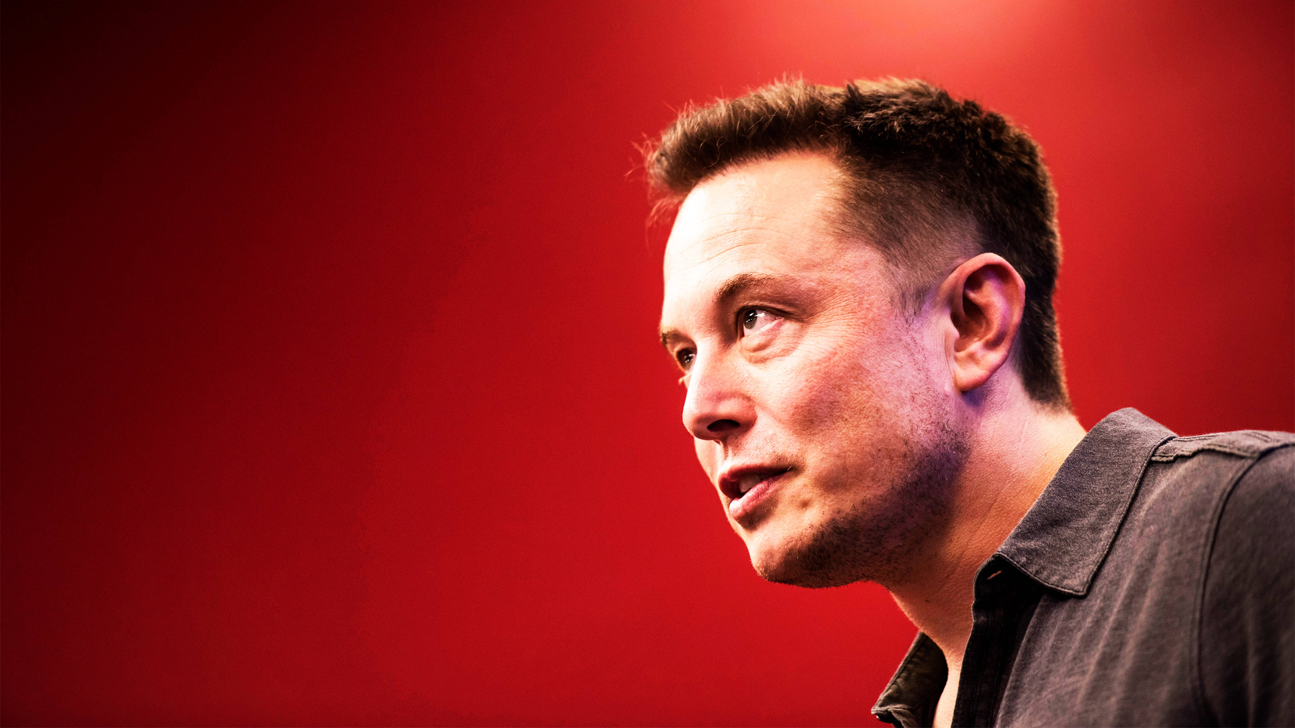 Elon Musk against a red background