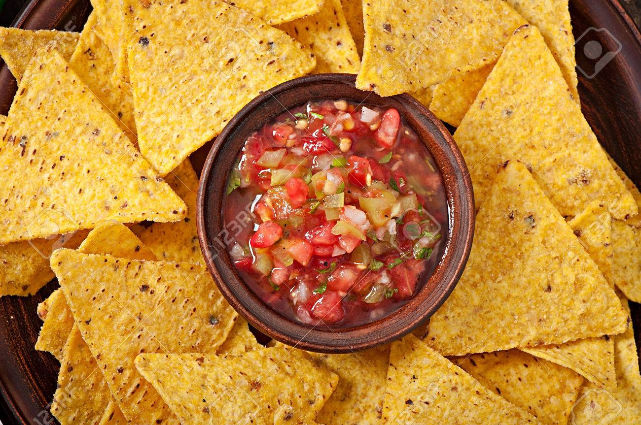 Mexican Nacho Chips And Salsa Dip In Bowl On Wooden Background