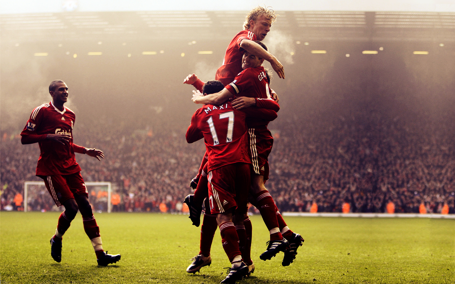Liverpool players celebrating a goal in a packed stadium