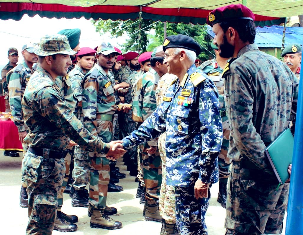 A military officer shaking hands with another officer in a military camp