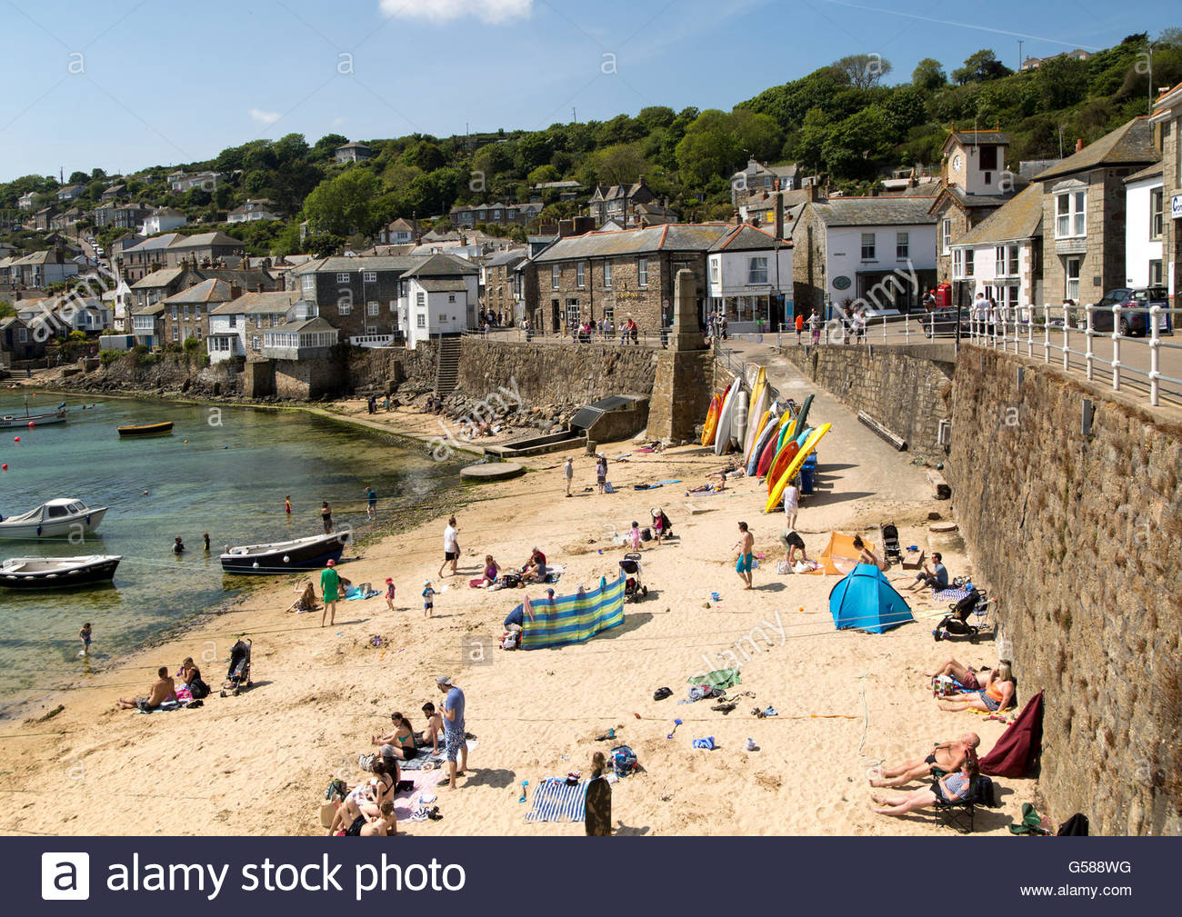 People On Crowded Beach In Mousehole Village Stock Photos