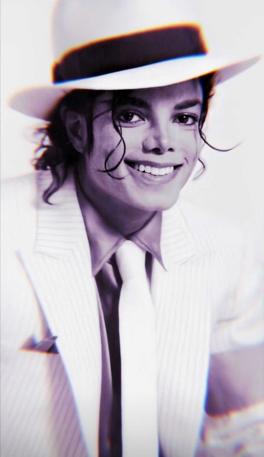 Michael Jackson in a white suit and hat
