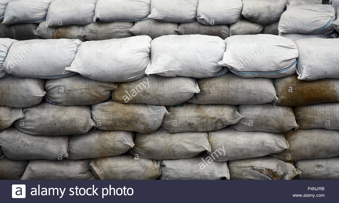 Background Of Many Dirty Sand Bags For Flood Defense Protective