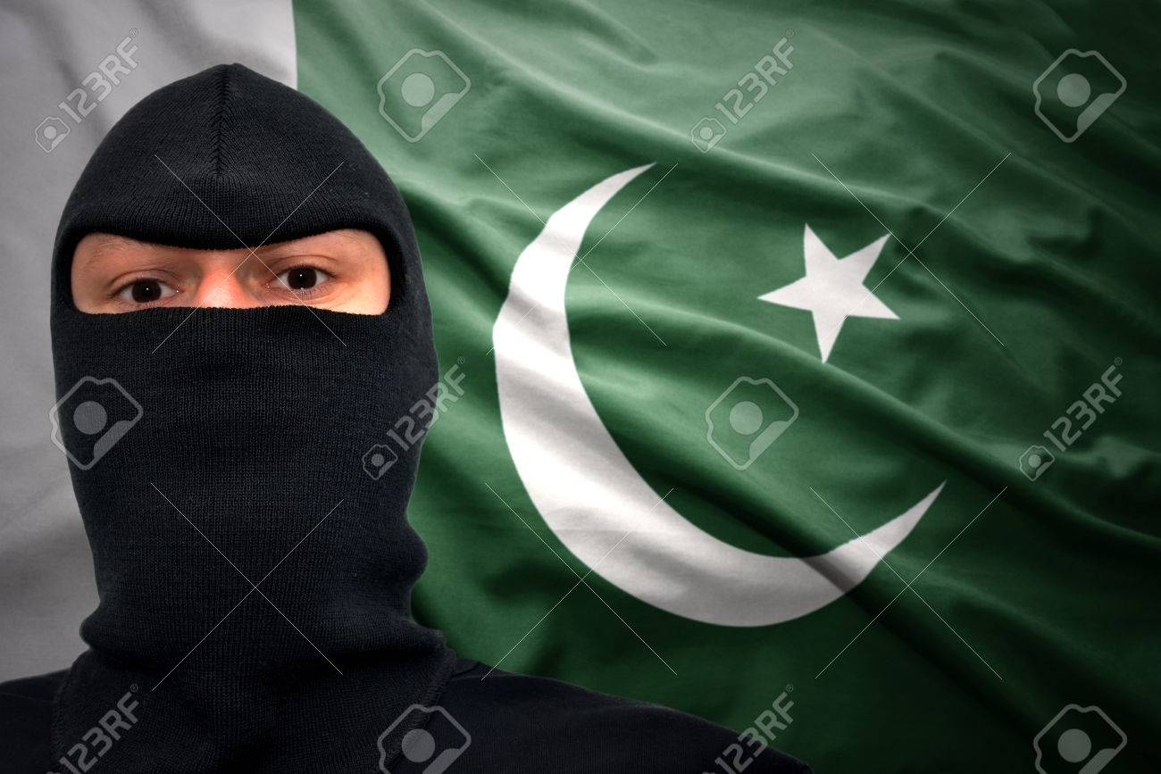 Dangerous Man In A Mask On Pakistani Flag Background Stock Photo