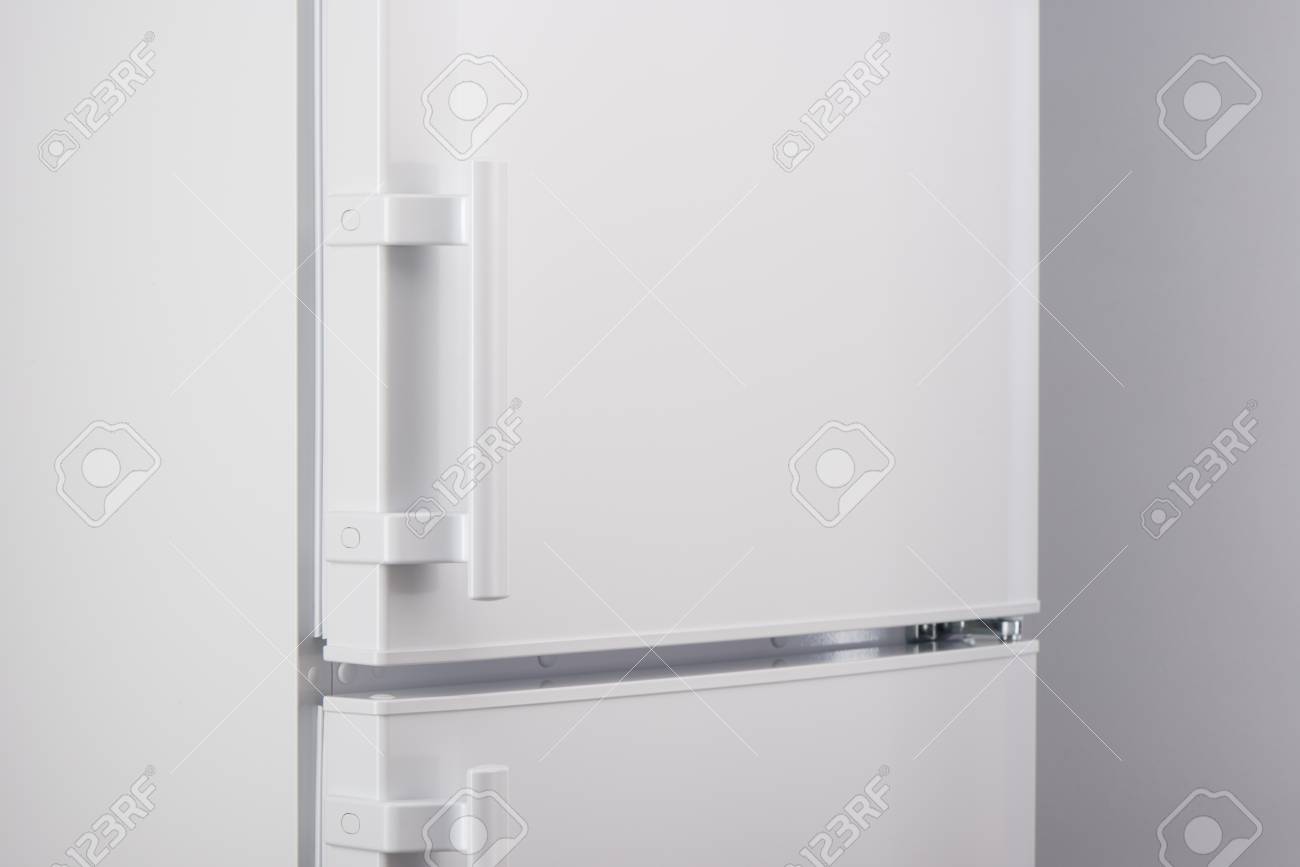 Close Up Of White Refrigerator On Gray Background Stock Photo