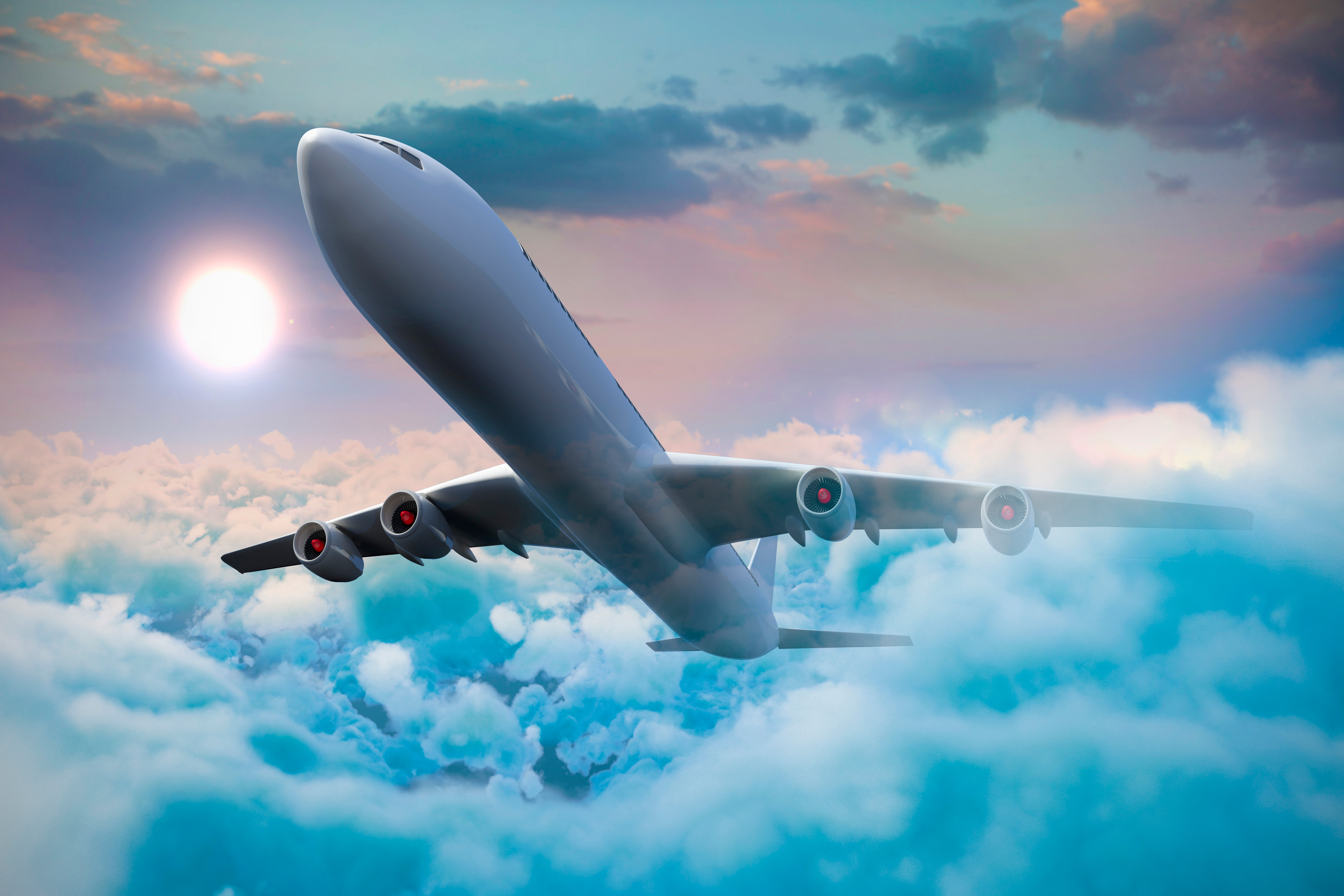 A passenger airplane soaring through a beautiful cloudscape at sunset