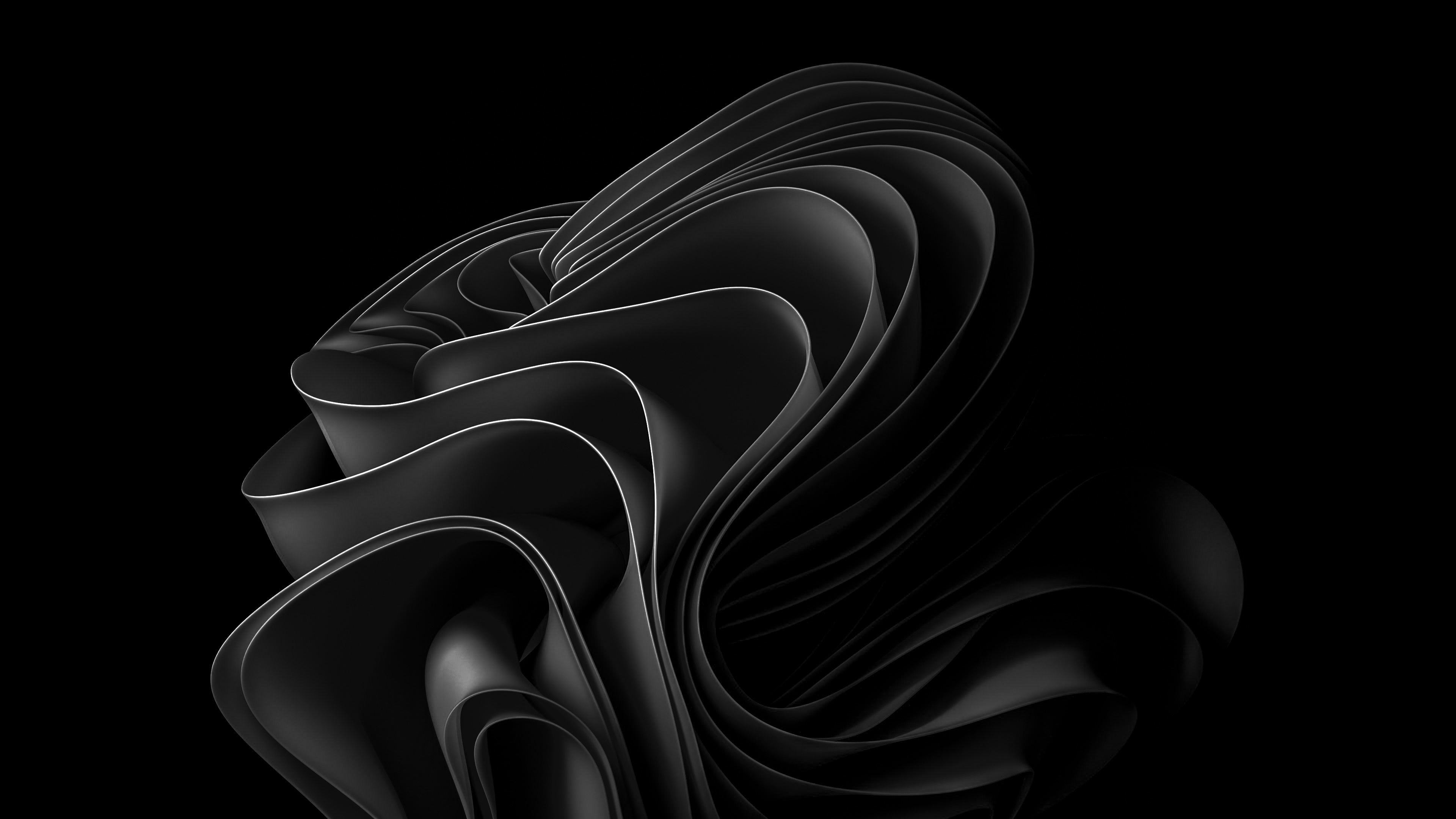 A captivating abstract image featuring dark, undulating forms against a pure black backdrop. The play of light and shadow enhances the three-dimensional effect, creating a sense of depth and movement