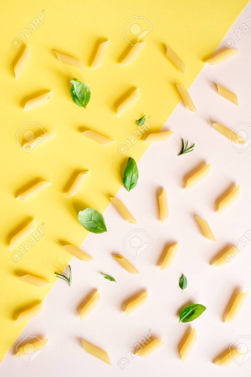 Penne Pasta On Pink Pastel And Yellow Background Top Flat