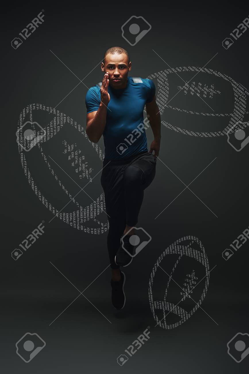 Handsome Sportsman Is Ready To Run Jumping Over Dark Background