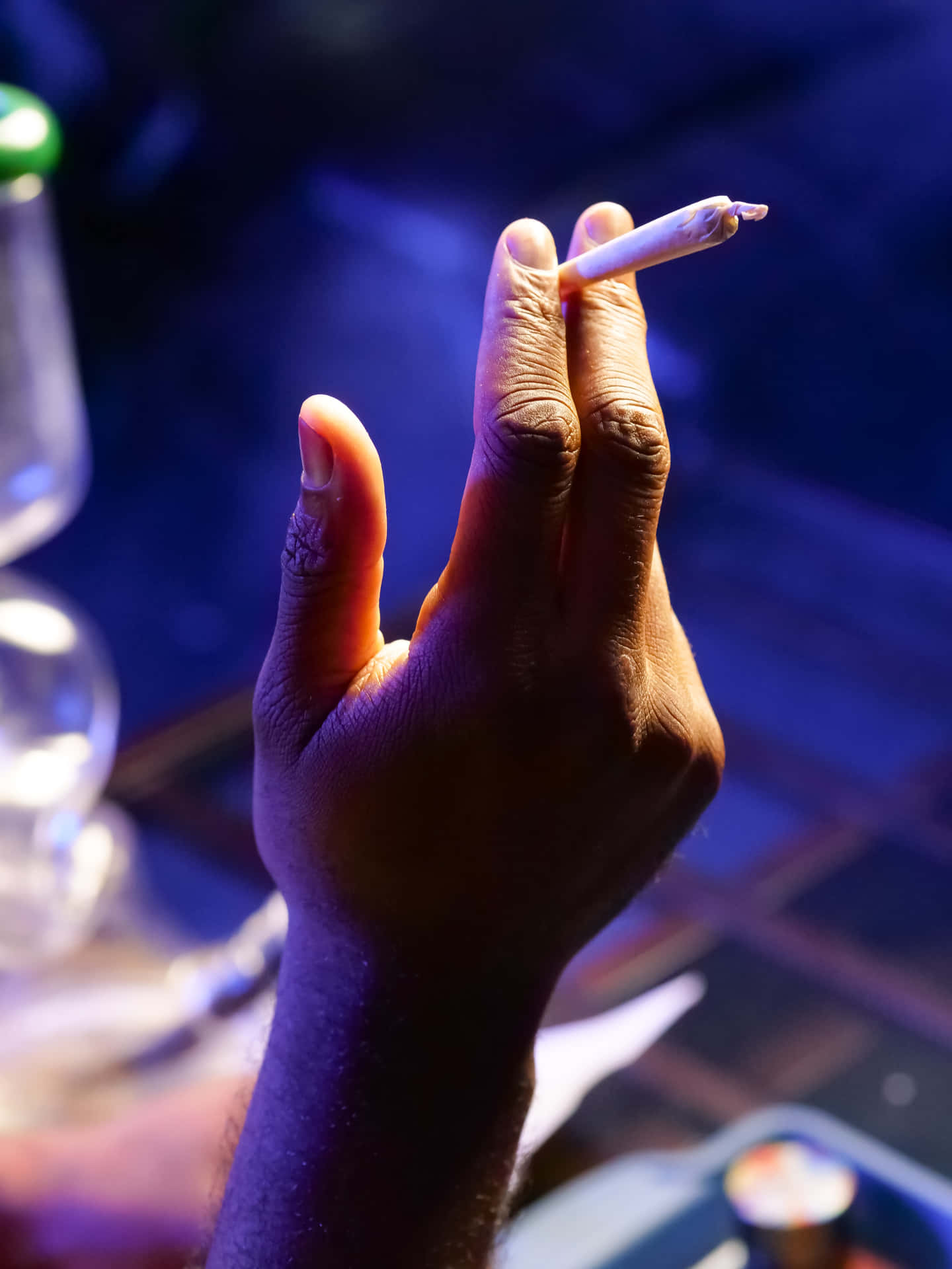 A Person Is Holding Cigarette In Their Hand Wallpaper