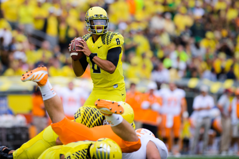 Sophomore Quarterback Marcus Mariota Searches The Field For An