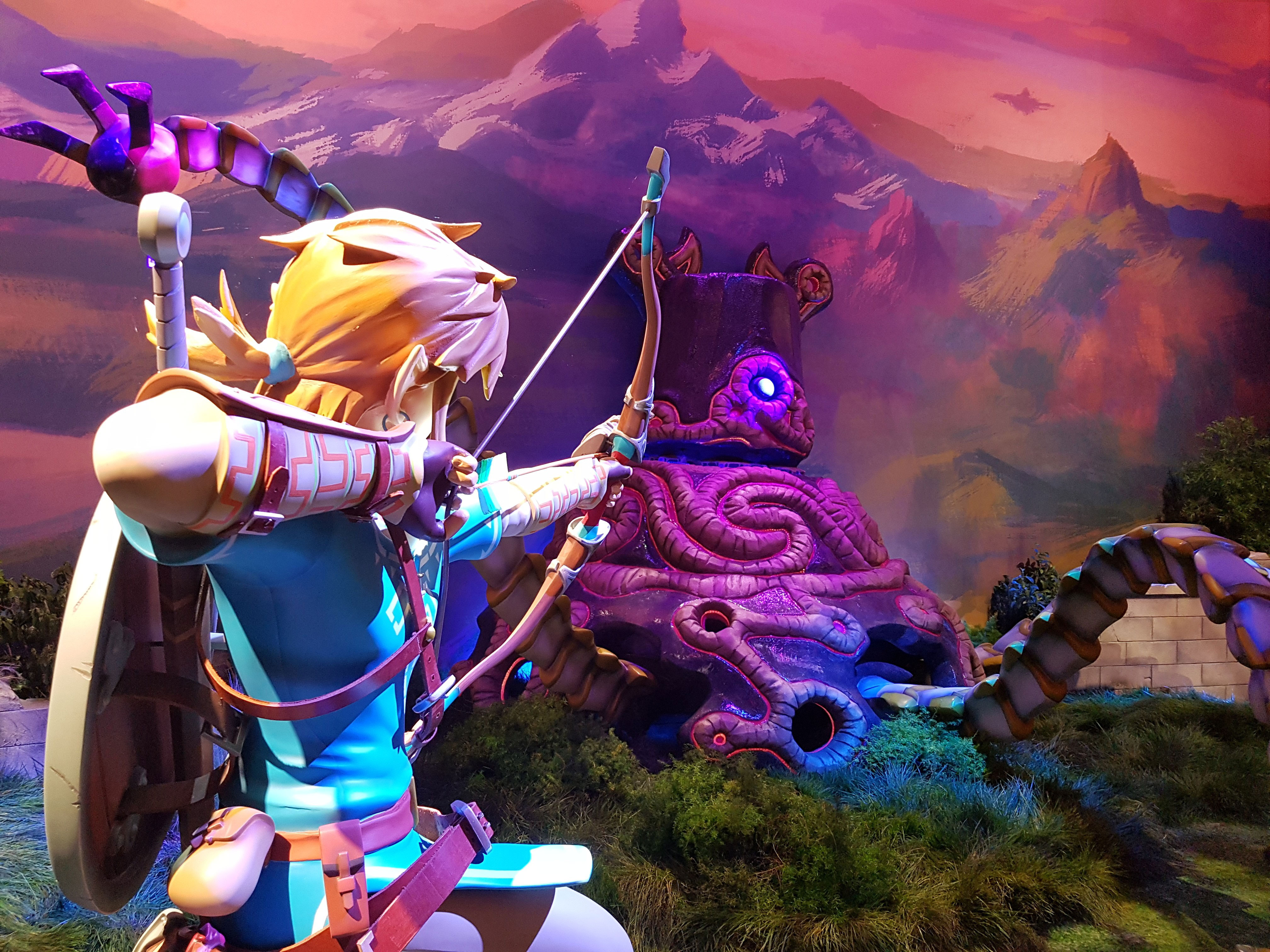 Link aiming his bow and arrow at a Calamity Ganon Blight from the Legend of Zelda: Breath of the Wild video game