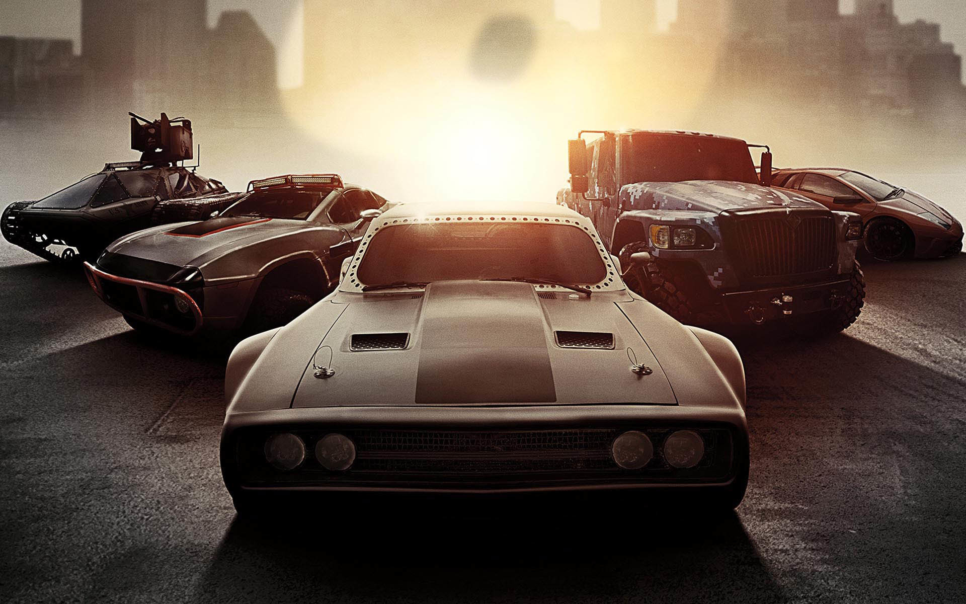 Fast and Furious cars lined up, featuring a Dodge Charger, a modified off-road vehicle, a militarized truck, and a sports car
