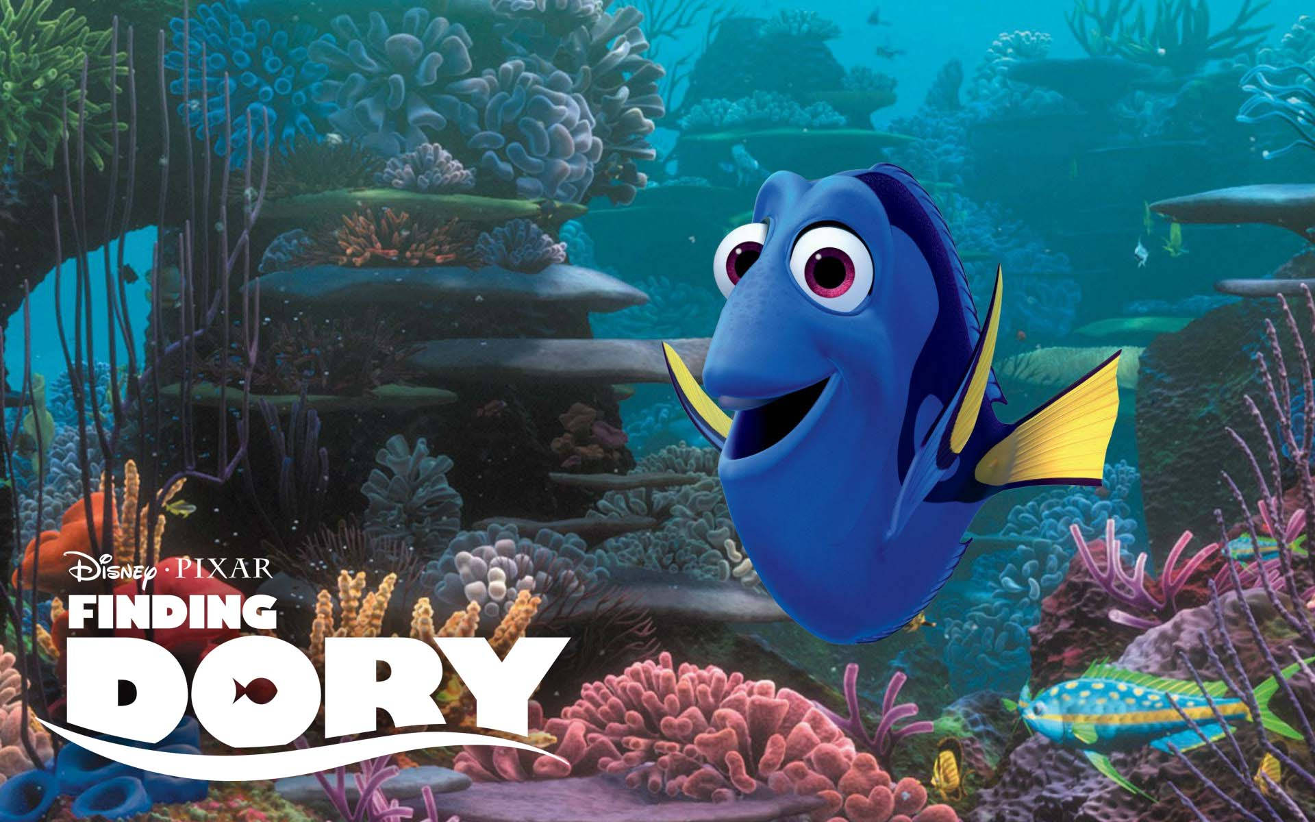 Dory, the regal blue tang fish, swims through a vibrant coral reef in a promotional image for 'Finding Dory'