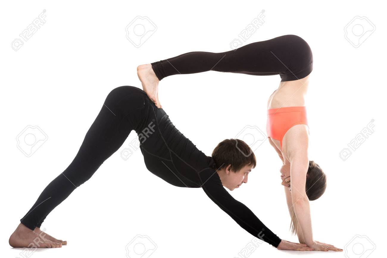 Sporty Couple On White Background Doing Acroyoga Yoga With