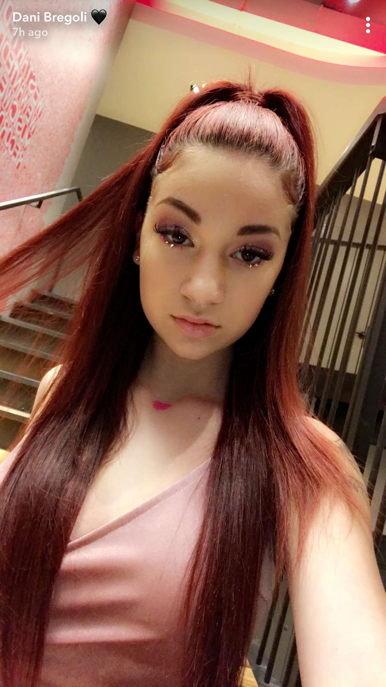 Bhad Bhabie selfie with long red hair and a pink top