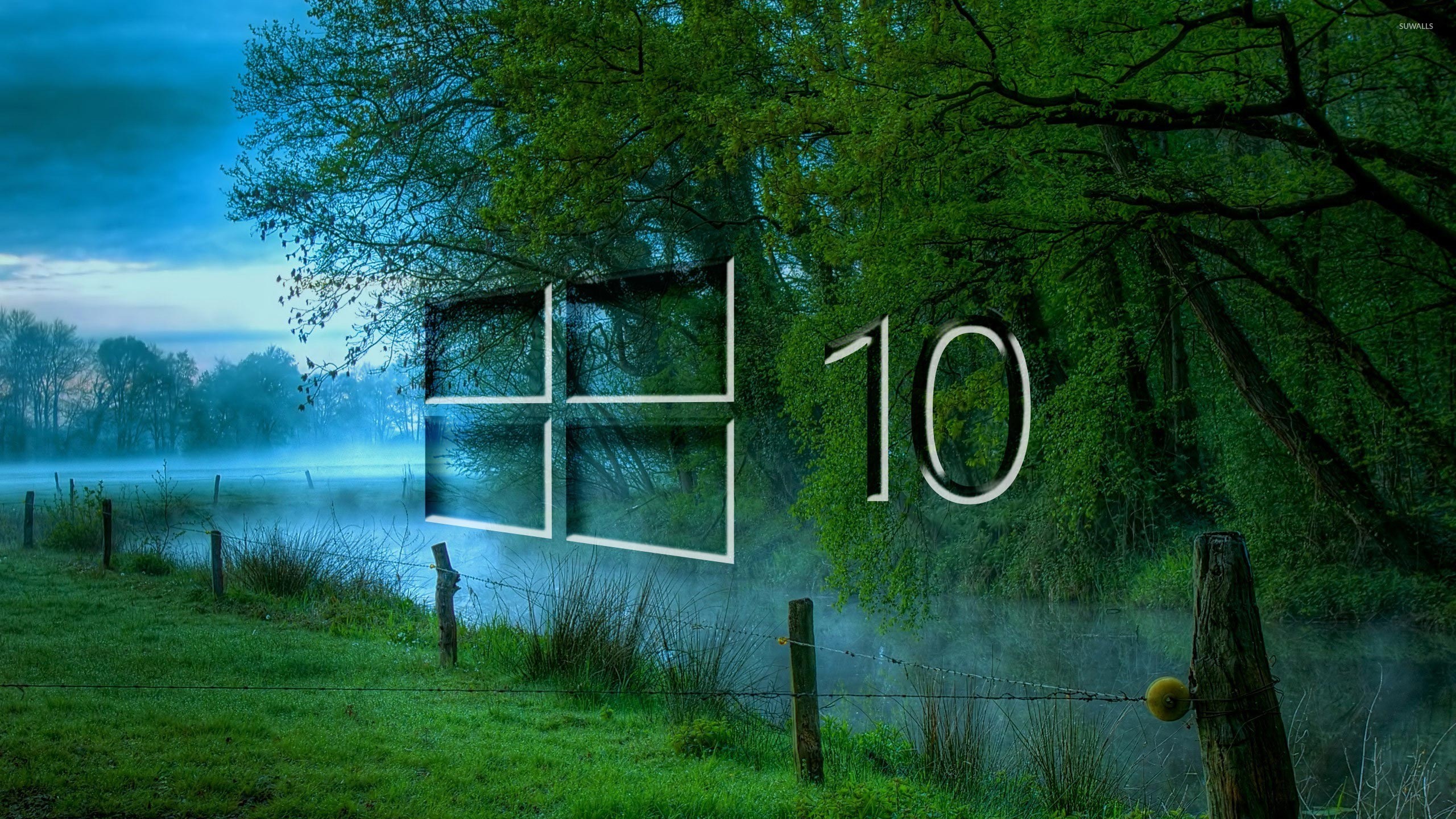 Windows 10 logo superimposed on a serene landscape with a misty river and lush green trees