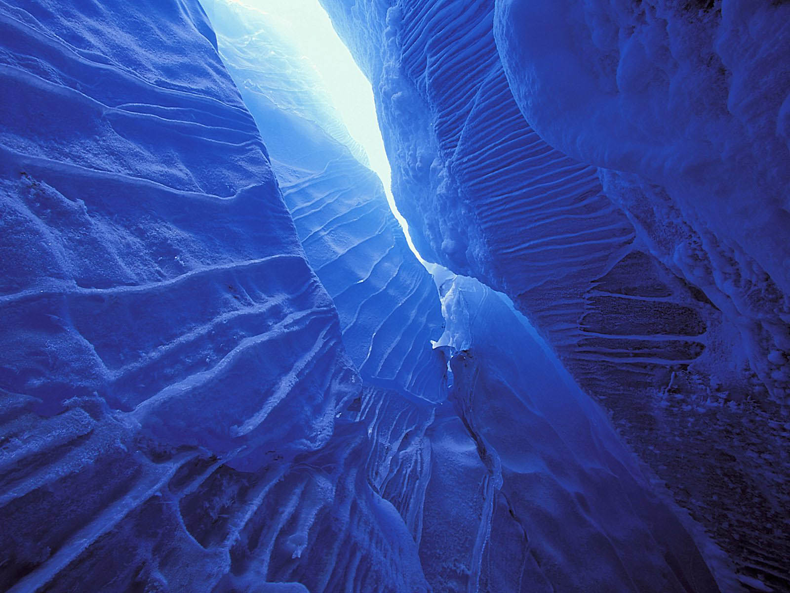 A breathtaking view inside a deep blue ice cave, showcasing the natural beauty of ice formations