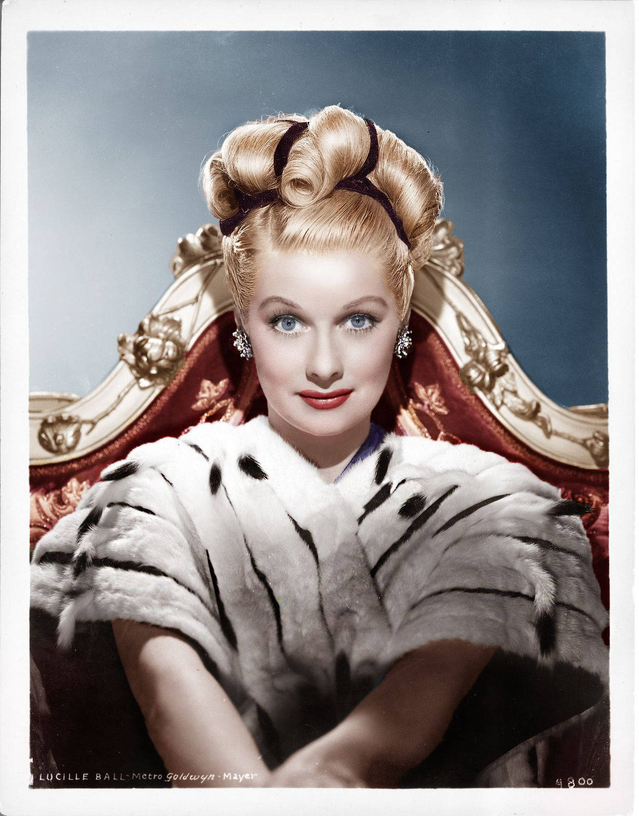 Lucille Ball Sitting On Red Chair Wallpaper