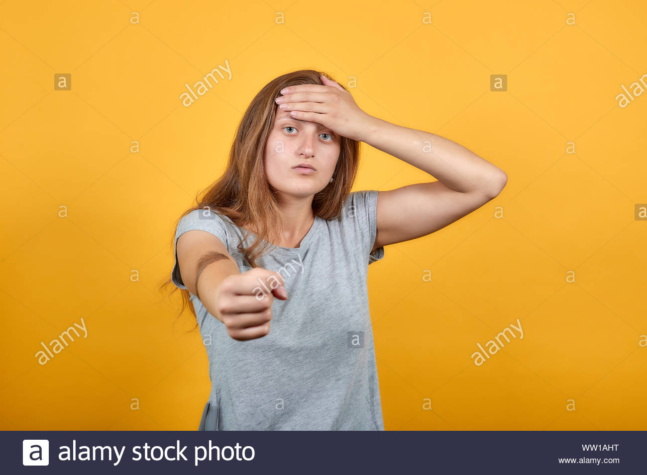 Brute Girl In Gray T Shirt Over Isolated Orange Background