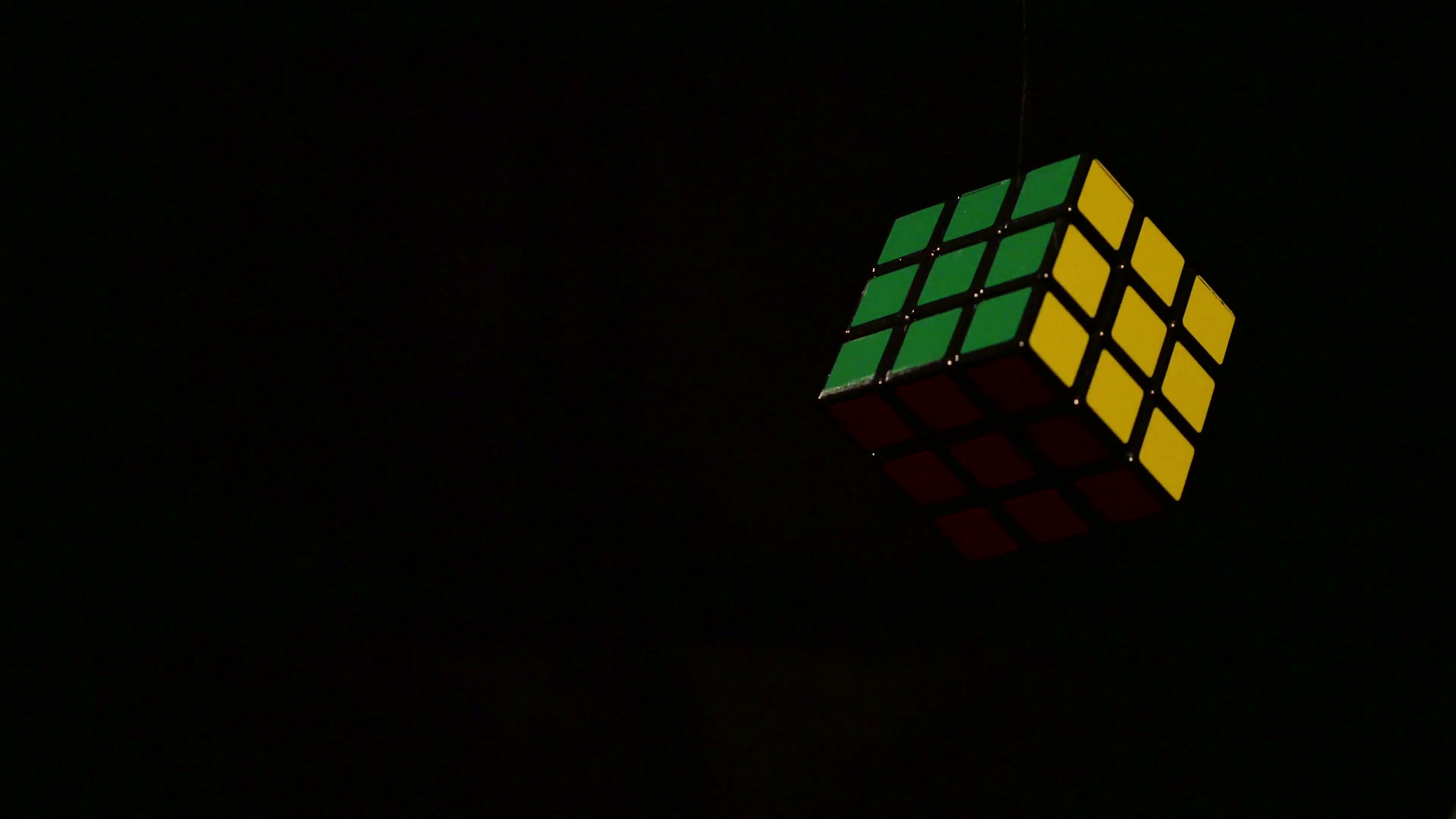 A Rubik S Cube Being Rotated Over Black Background Stock