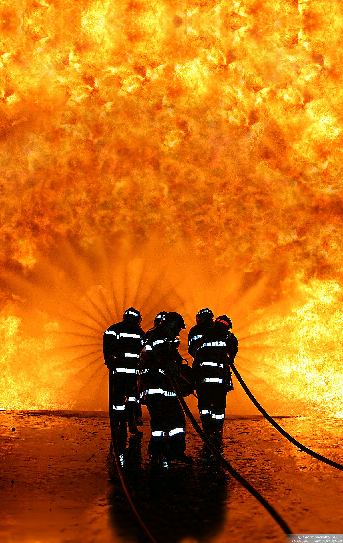 Incredible Orange Blaze Silhouettes Firefighters Spraying Water