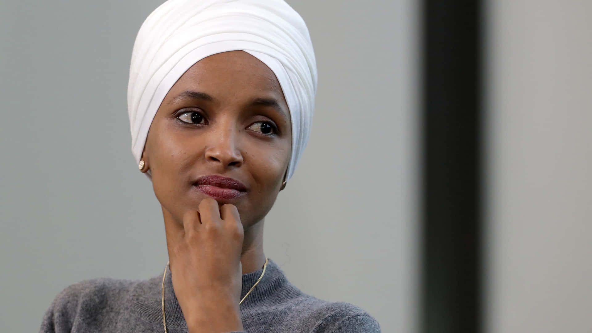 Us Representative Ilhan Omar Posing With A Contemplative Wallpaper