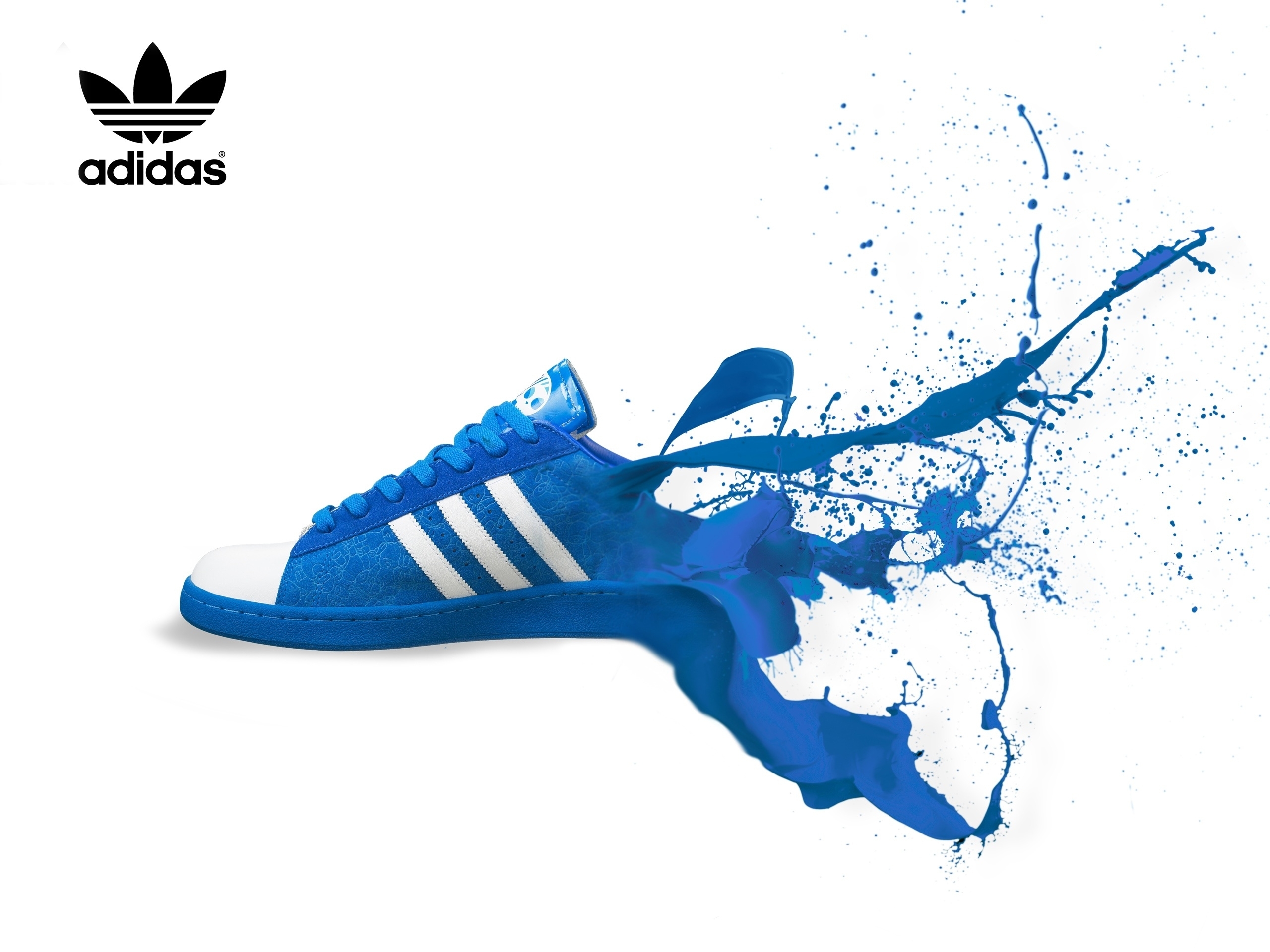 Blue Adidas Superstar shoe with splashing blue paint, against a white background