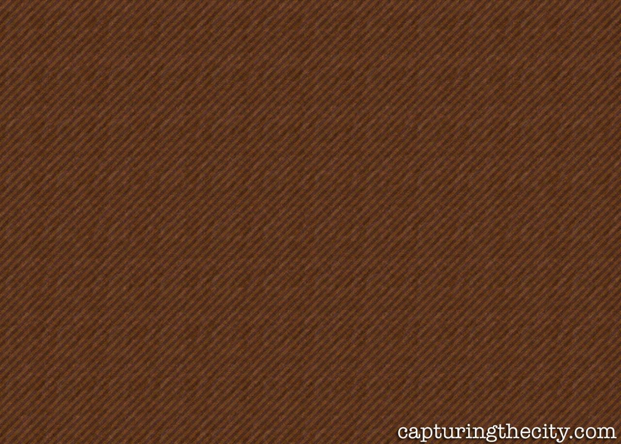 A close-up of a textured brown wallpaper with a subtle diagonal weave pattern