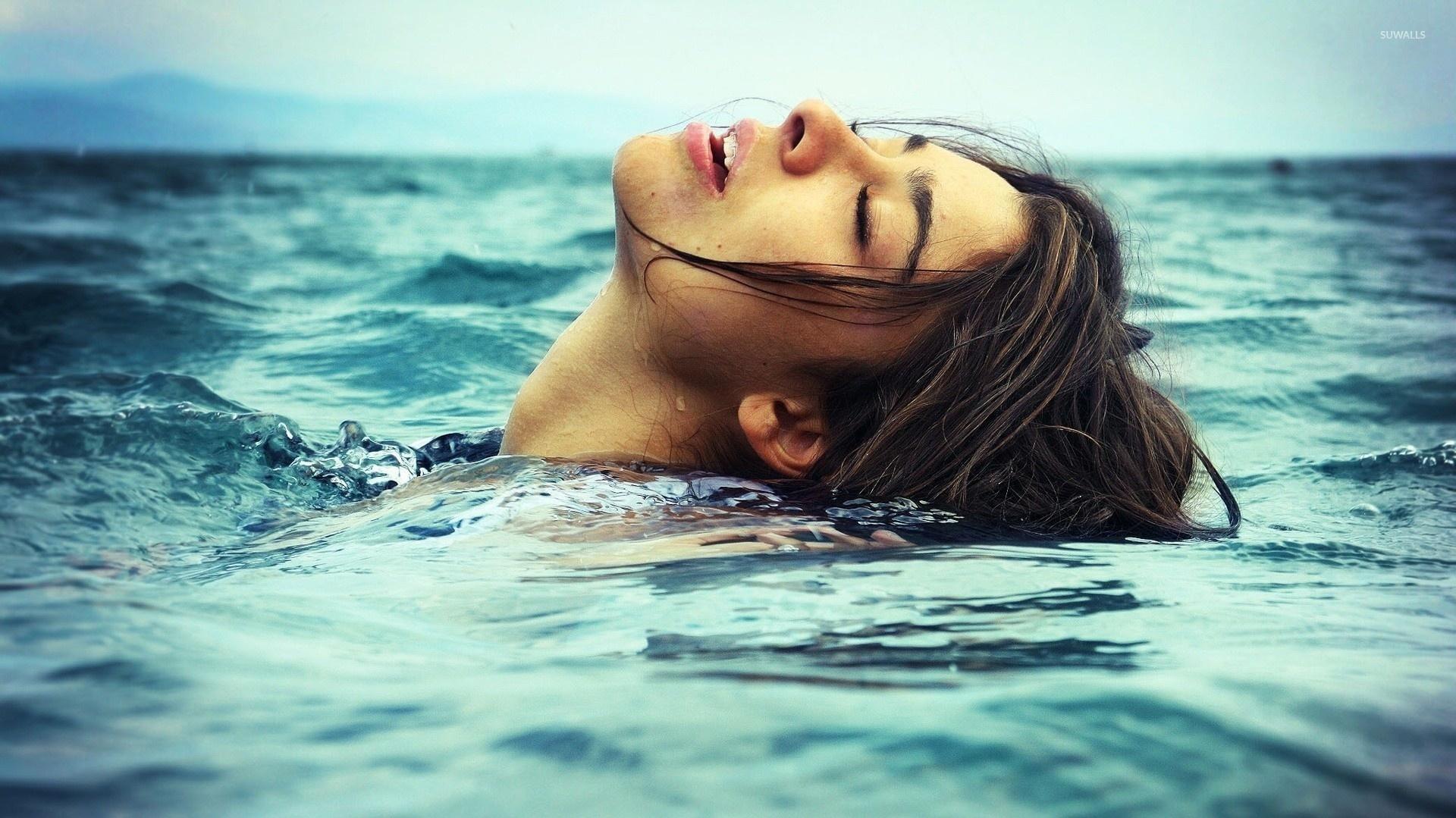 Girl Relaxing In The Ocean Wallpaper