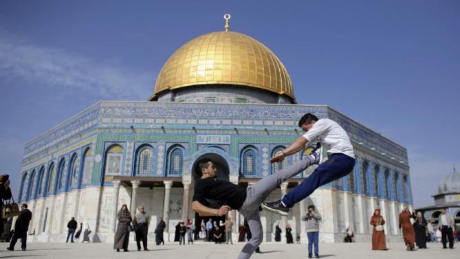 The Dome Of Rock Is Seen In Background As Palestinian Youths
