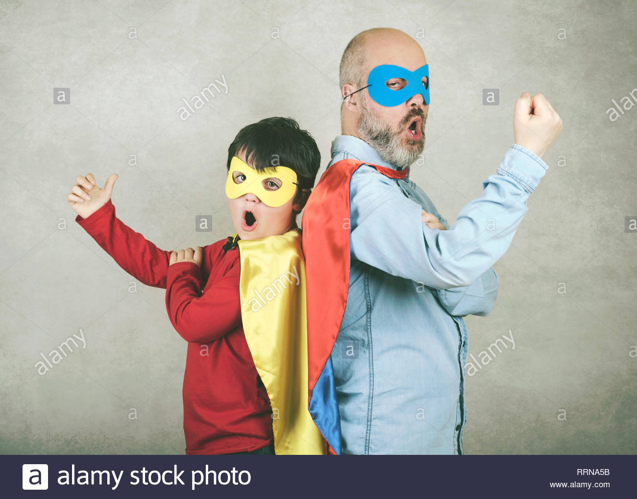 Father S Day And Son Dressed As A Superhero Against Gray