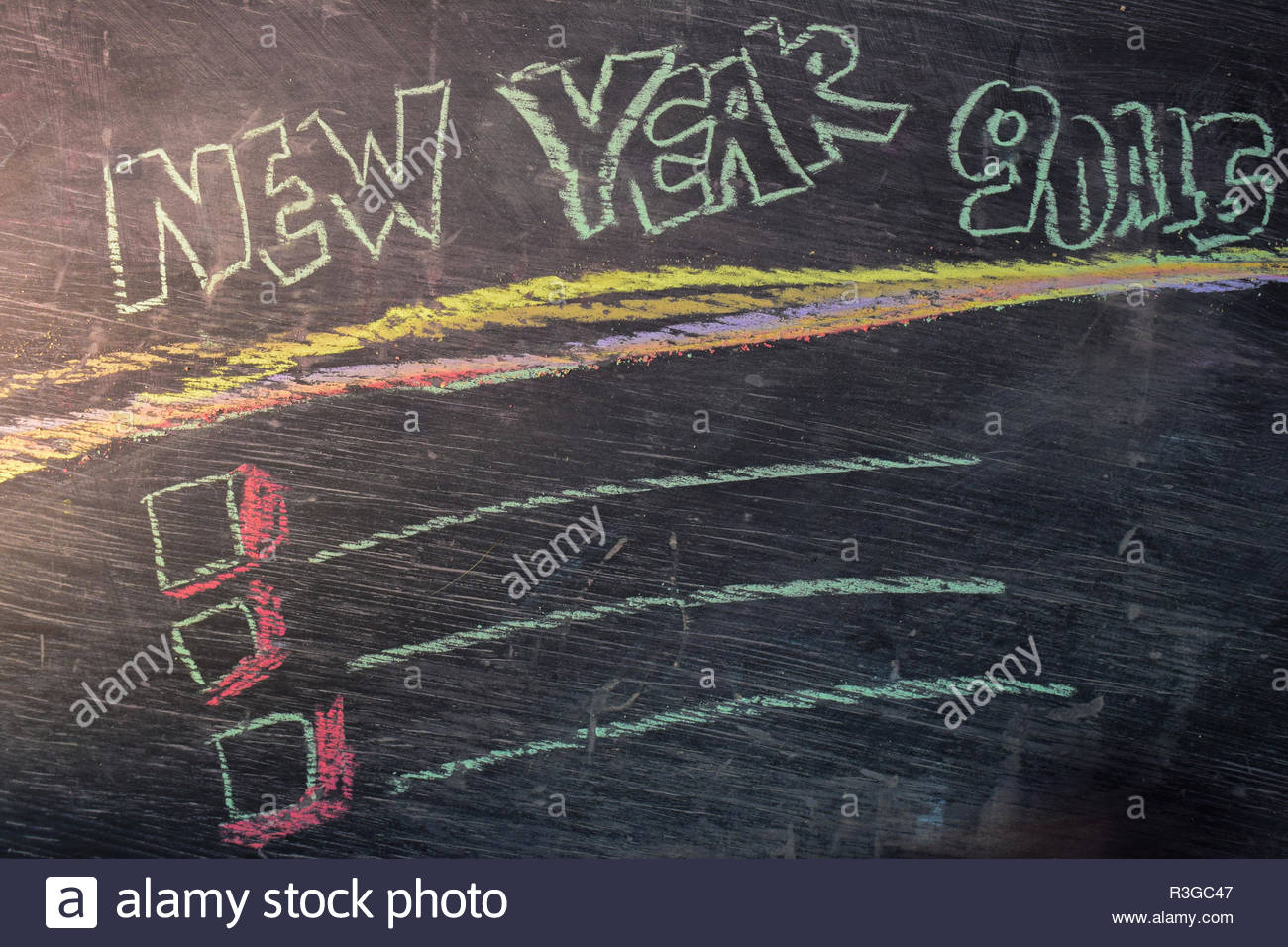 New Year Goals Handwritten Text With Colorful Chalk On Blackboard