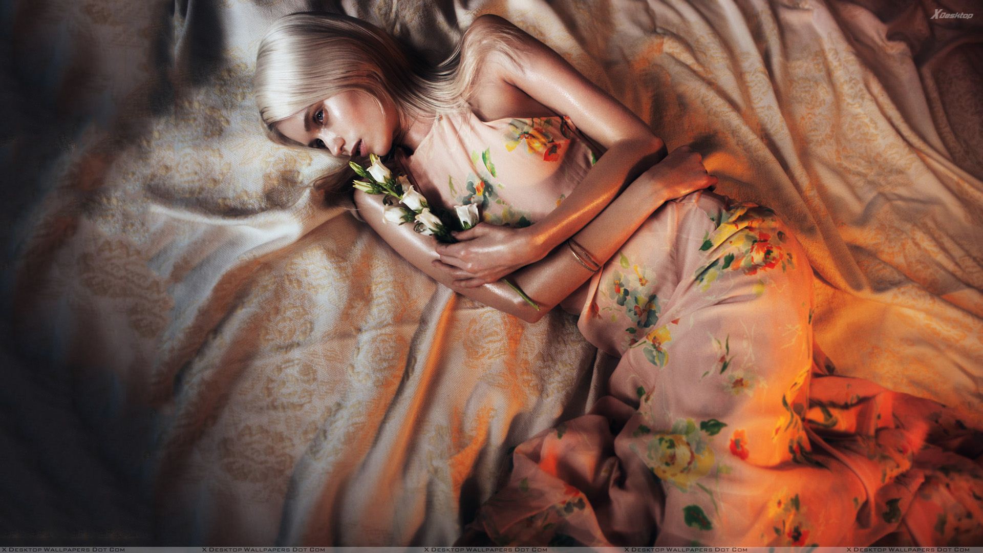 Abbey Lee Kershaw Laying On Bed In Colorful Dress Wallpaper