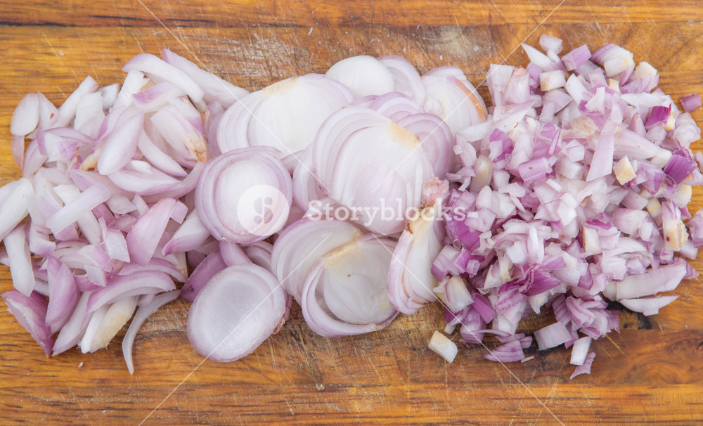 Chopped Shallot On Cutting Board Over White Background Royalty