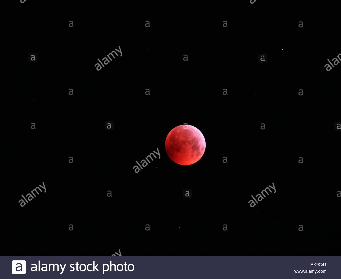 Bloodmoon In The Sky With Stars Background Stock Photo