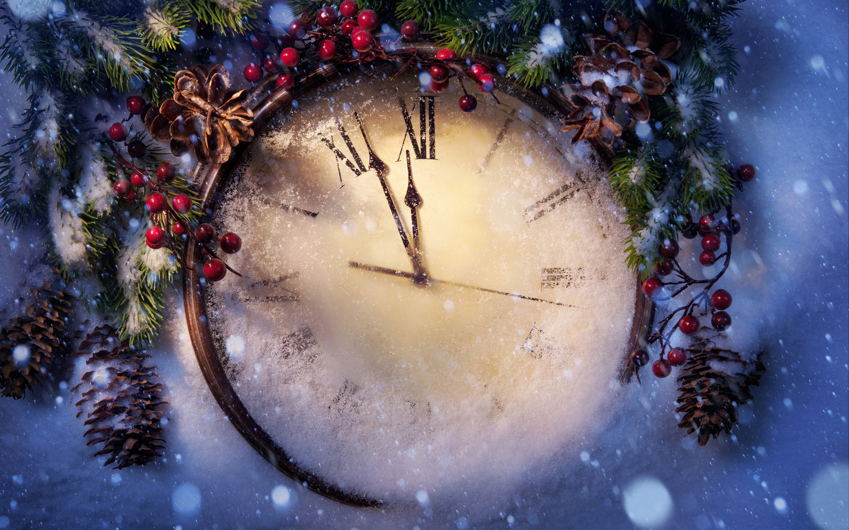 New Year's Eve clock face covered in snow, surrounded by pine branches, pine cones, and red berries. The clock hands are approaching midnight